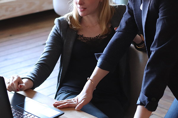 Two businesswomen talking and giving guidance