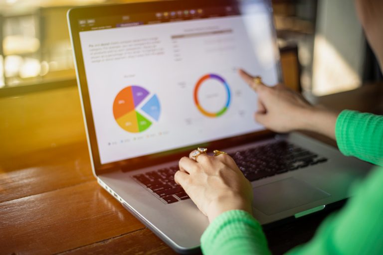 Woman looking at reports on laptop