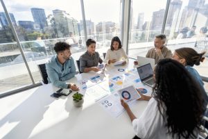 diverse group of workers in a business presenting financial projections